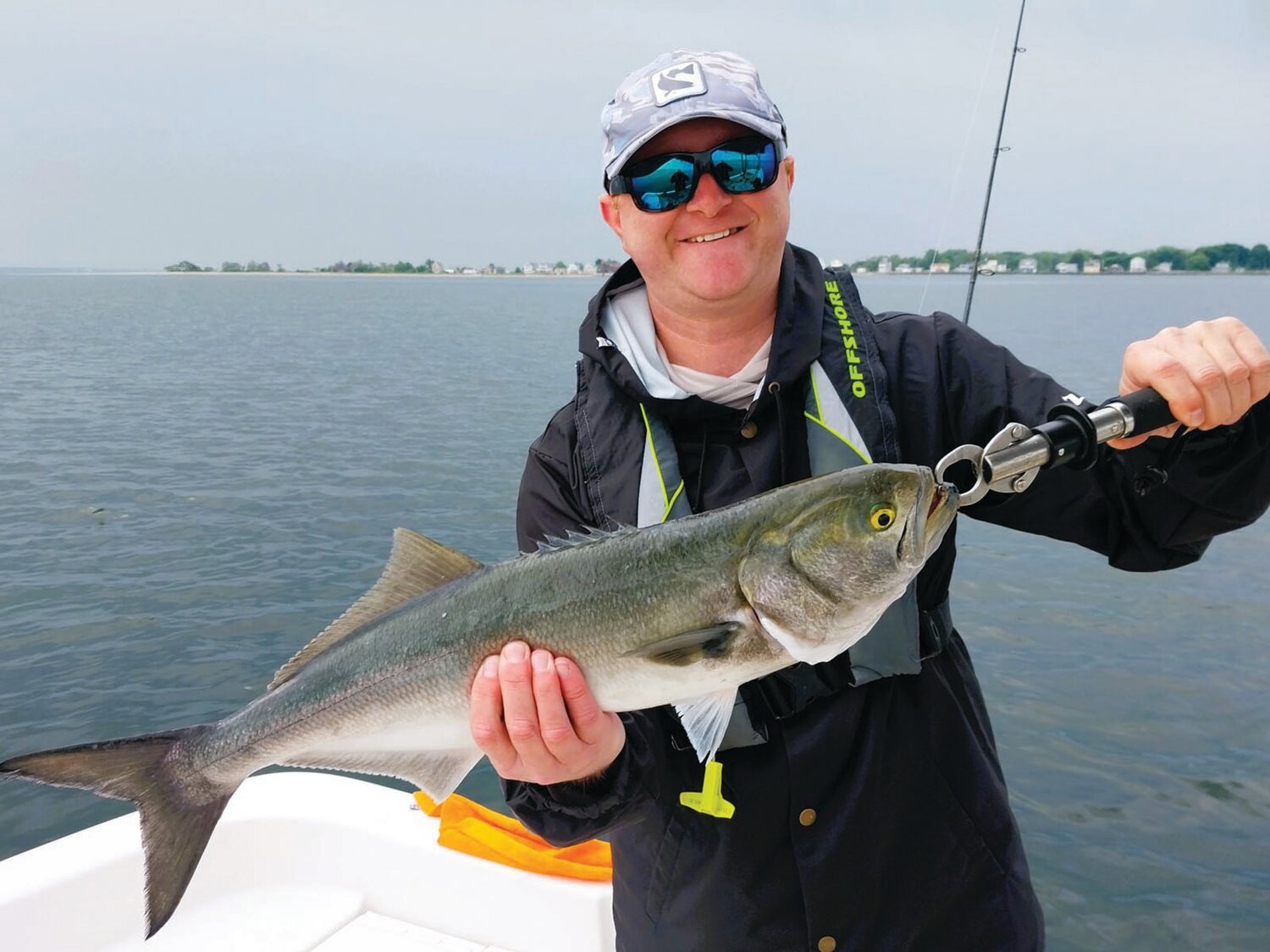 NOT SINGING THE BLUES: Brandon Davis said, “These bluefish are large compared to what we have in Chesapeake Bay, Maryland area.  And they are a lot of fun to catch.”
